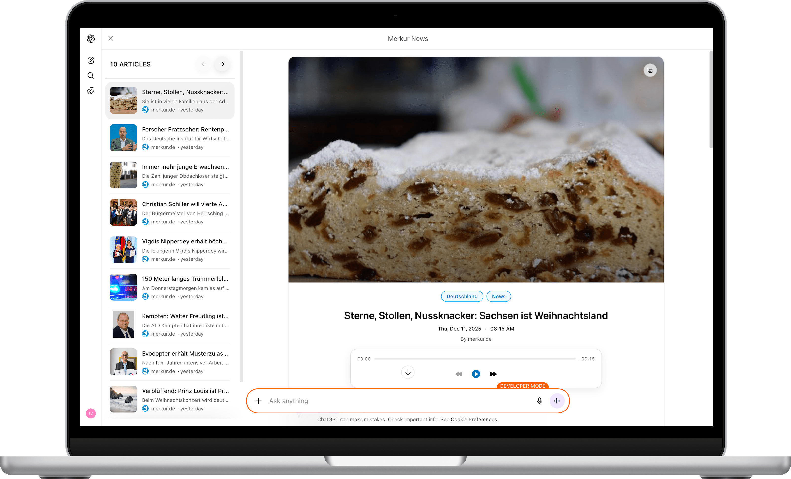 MacBook showing Merkur News app with article list and reader